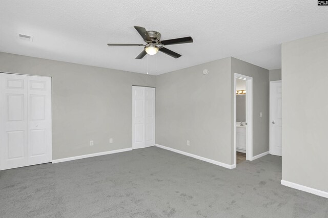 817 Wickham Ln, Columbia, SC 29229 - unfurnished bedroom with carpet floors, a textured ceiling, multiple closets, baseboards, and visible vents