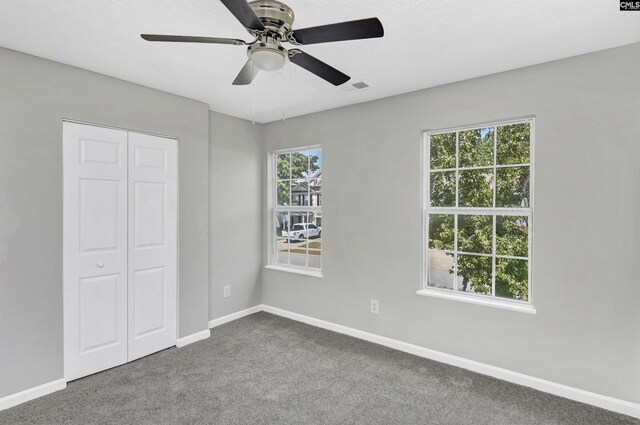 817 Wickham Ln, Columbia, SC 29229 - unfurnished bedroom with multiple windows, a closet, baseboards, and carpet flooring