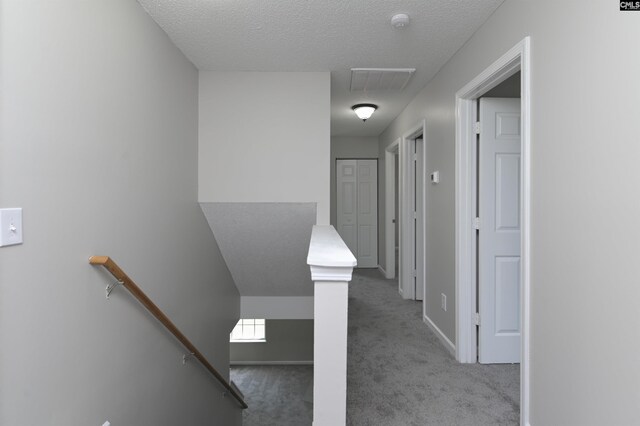 817 Wickham Ln, Columbia, SC 29229 - hallway with an upstairs landing, carpet floors, a textured ceiling, baseboards, and visible vents