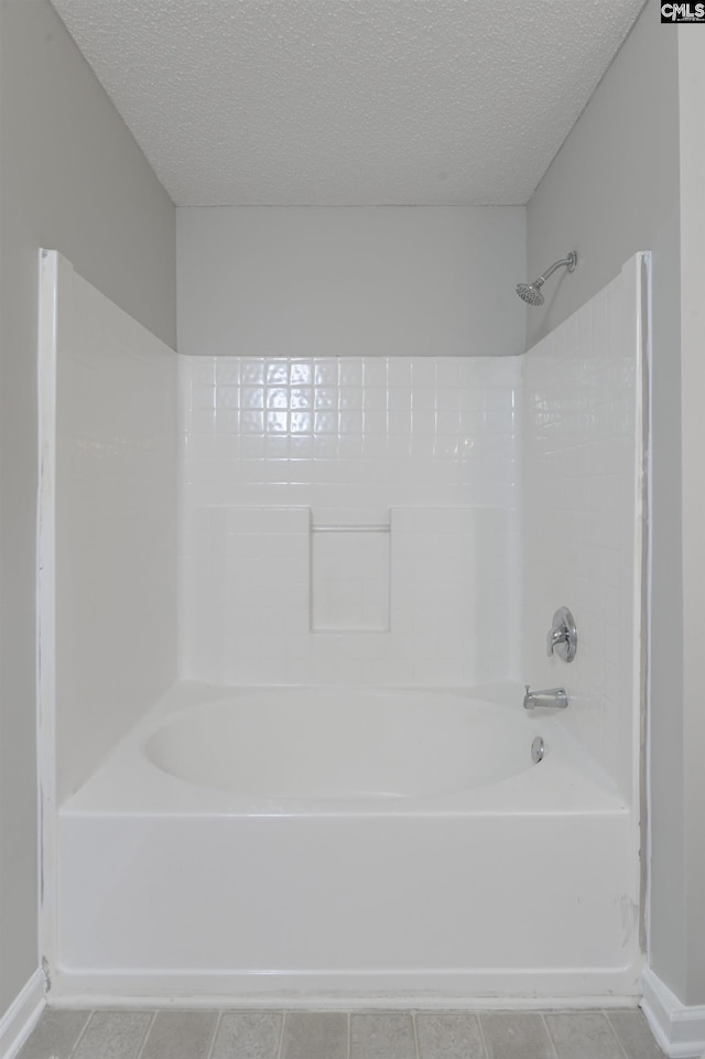817 Wickham Ln, Columbia, SC 29229 - bathroom featuring tile patterned floors, shower / bath combination, baseboards, and a textured ceiling