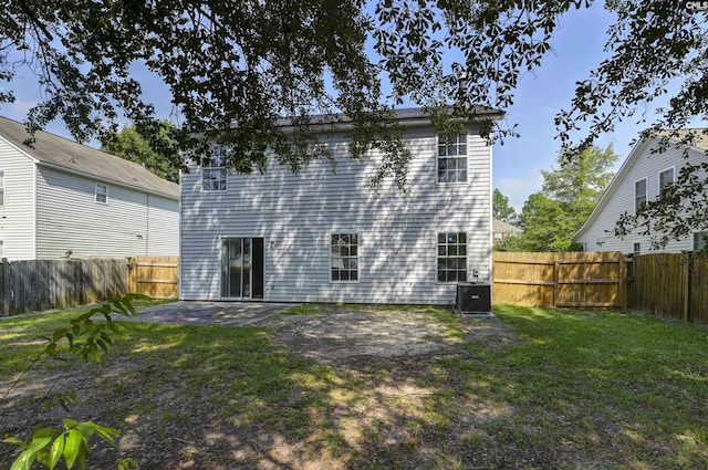 817 Wickham Ln, Columbia, SC 29229 - rear view of house with a fenced backyard, a patio, central AC unit, and a yard