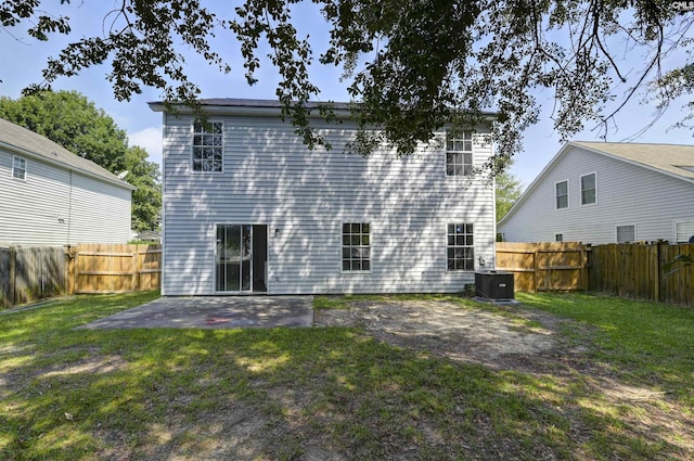 817 Wickham Ln, Columbia, SC 29229 - rear view of property featuring a fenced backyard, a lawn, central air condition unit, and a patio area