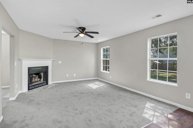 817 Wickham Ln, Columbia, SC 29229 - unfurnished living room with a fireplace with flush hearth, baseboards, carpet floors, visible vents, and a ceiling fan