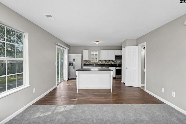 817 Wickham Ln, Columbia, SC 29229 - kitchen with white cabinetry, tasteful backsplash, stainless steel appliances, a kitchen island, and dark countertops