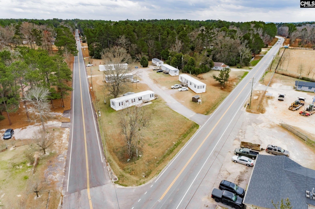 birds eye view of property featuring a wooded view