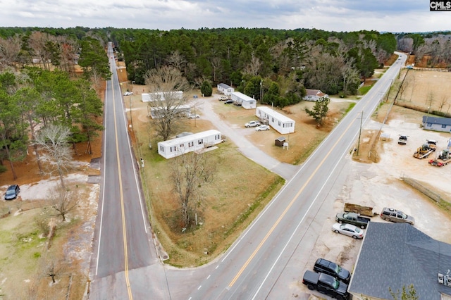 birds eye view of property featuring a wooded view