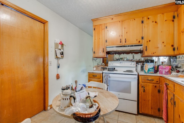 kitchen featuring light tile patterned flooring, a textured ceiling, and electric stove