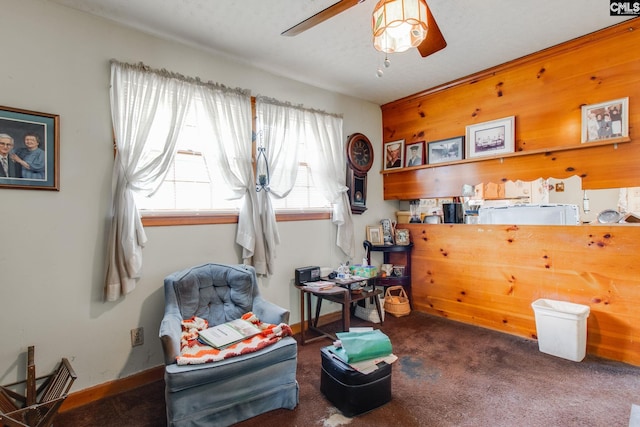 miscellaneous room with ceiling fan and dark colored carpet