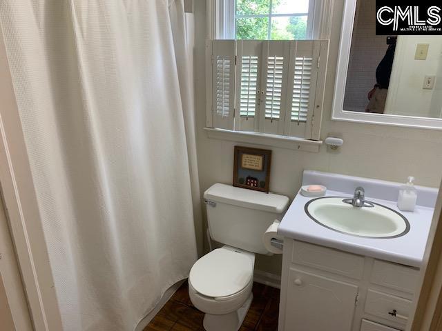 bathroom featuring toilet and vanity