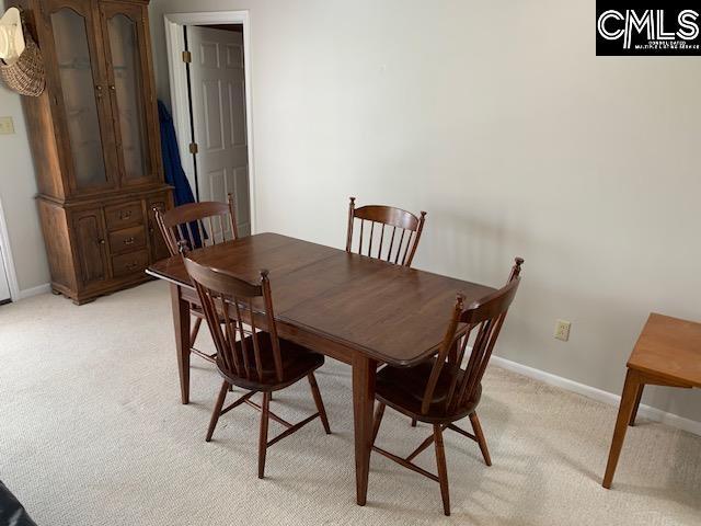 dining room featuring light carpet