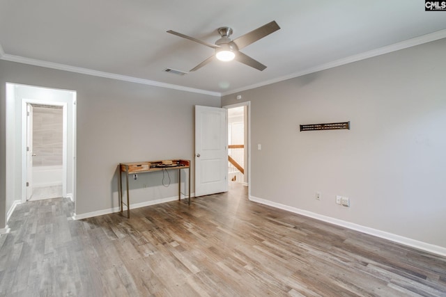 unfurnished room featuring ceiling fan, wood-type flooring, and ornamental molding