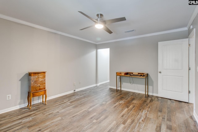 unfurnished room with ceiling fan, light wood-type flooring, and ornamental molding