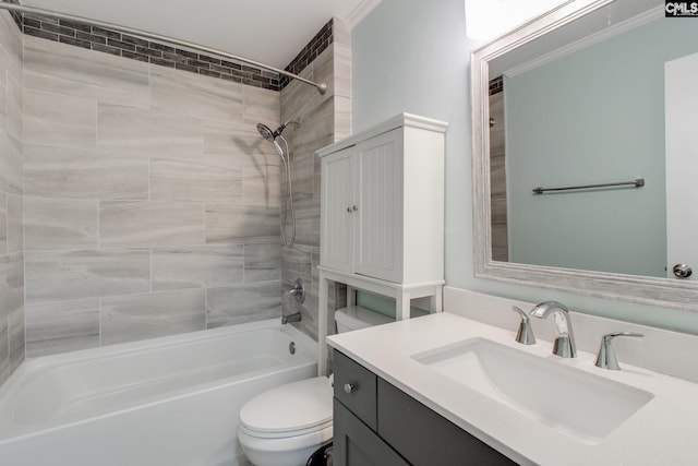 full bathroom featuring toilet, tiled shower / bath, and vanity