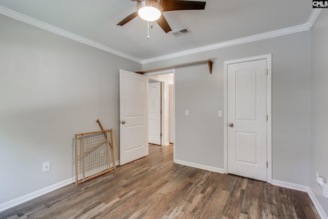 unfurnished bedroom featuring ceiling fan, dark wood-type flooring, and ornamental molding