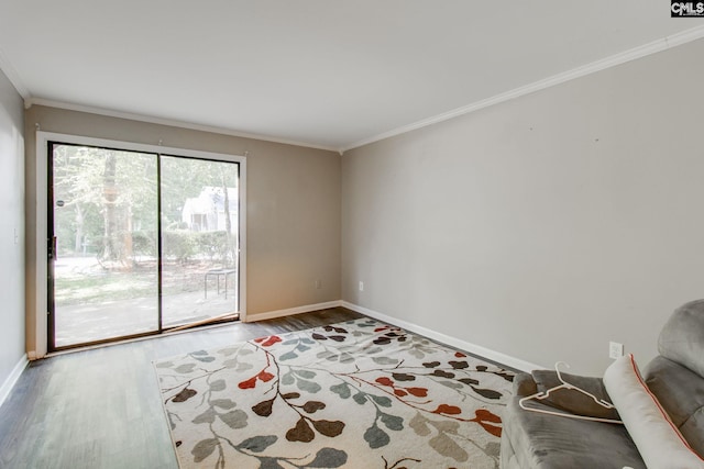 empty room featuring hardwood / wood-style flooring and crown molding