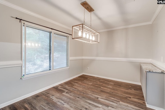 unfurnished dining area featuring dark wood-type flooring, plenty of natural light, and crown molding