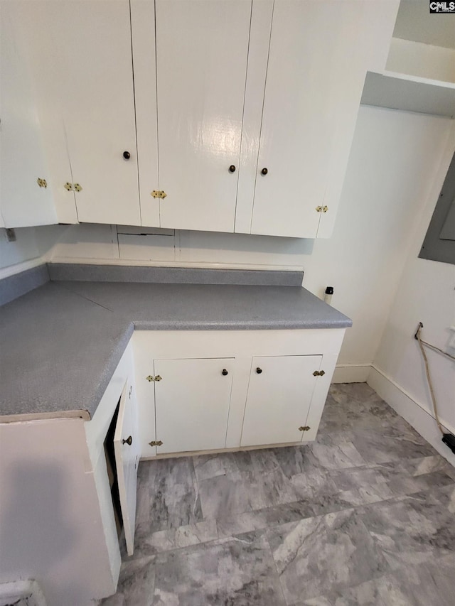 kitchen with white cabinetry and light tile patterned floors