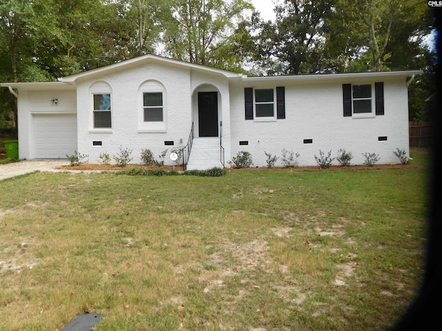 ranch-style house with a garage and a front lawn