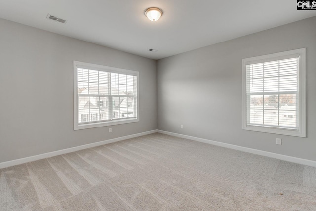 empty room featuring light colored carpet