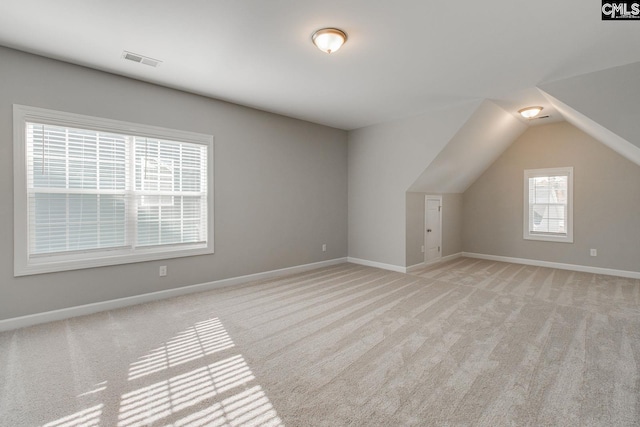 additional living space with light carpet and lofted ceiling