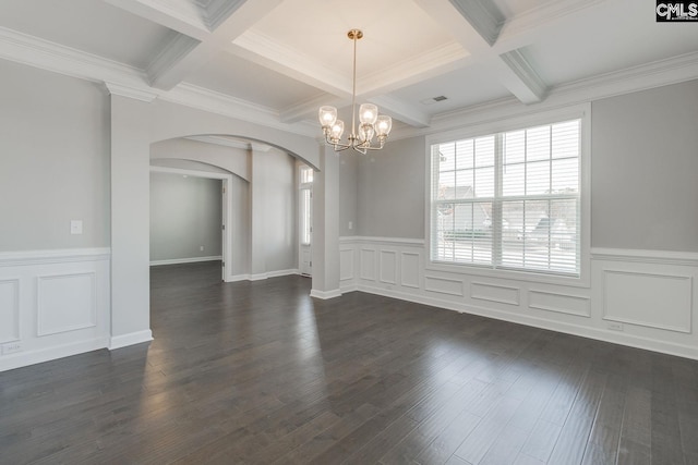 unfurnished dining area with dark wood-type flooring, beamed ceiling, an inviting chandelier, ornamental molding, and coffered ceiling