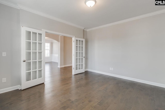 spare room with dark hardwood / wood-style floors, crown molding, and french doors