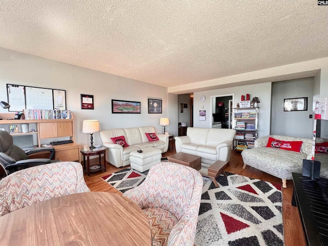 living room featuring a textured ceiling and hardwood / wood-style flooring