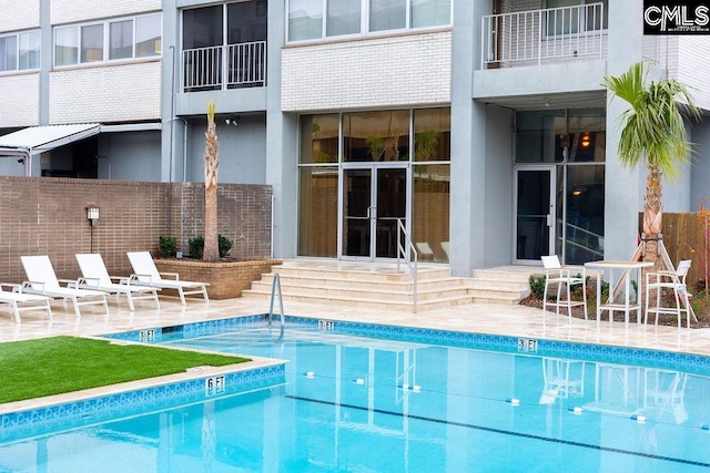 view of swimming pool with a patio