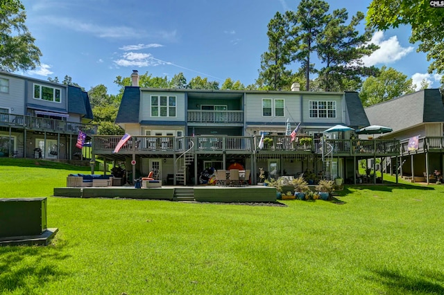 rear view of house with a yard and a wooden deck