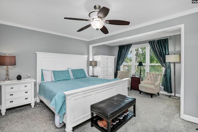 bedroom featuring light colored carpet, ornamental molding, and ceiling fan