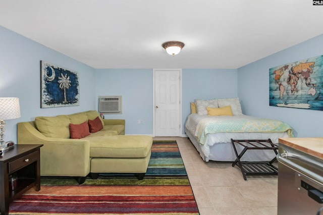 bedroom with a wall mounted air conditioner and light tile patterned floors