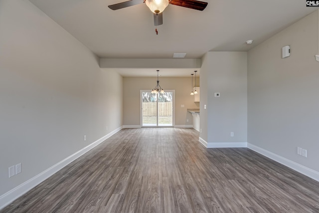 unfurnished living room with dark hardwood / wood-style flooring and ceiling fan