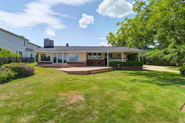 rear view of house with a lawn