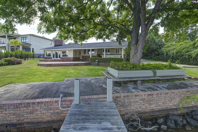 back of house with a yard, a chimney, and fence