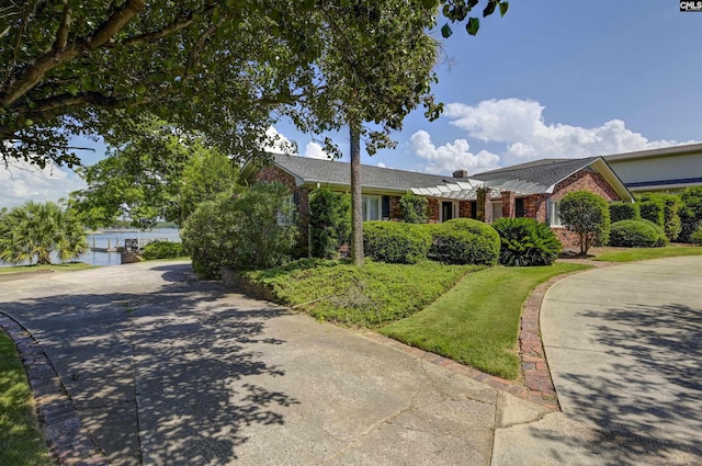 ranch-style home featuring concrete driveway and brick siding