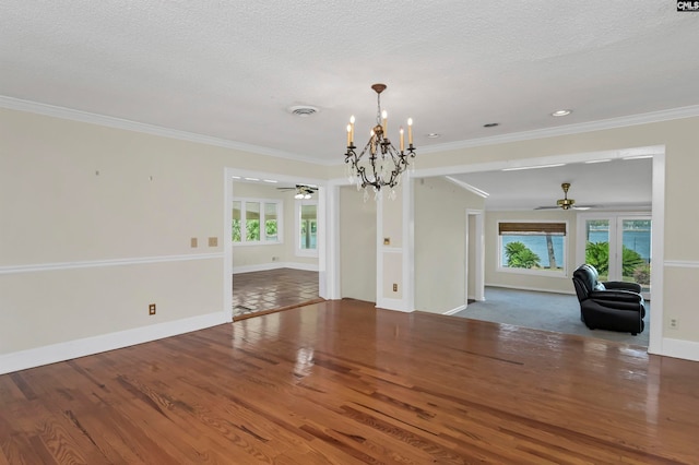 interior space with ceiling fan with notable chandelier, wood-type flooring, and ornamental molding