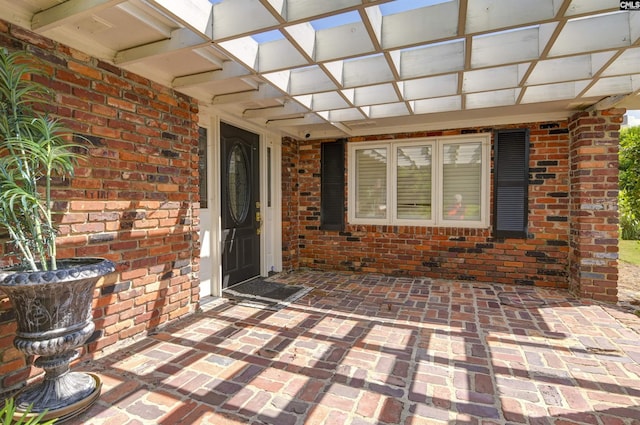 property entrance featuring brick siding