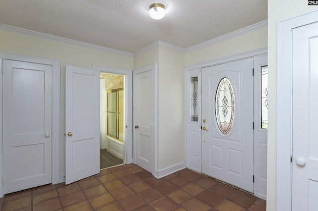 entrance foyer with a textured ceiling and ornamental molding