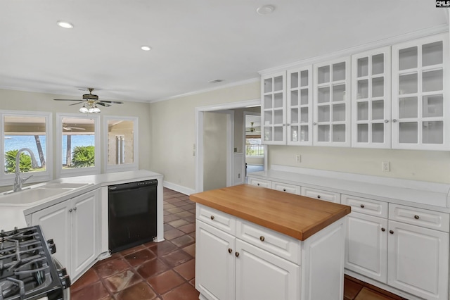 kitchen featuring butcher block counters, white cabinetry, a sink, gas range, and dishwasher