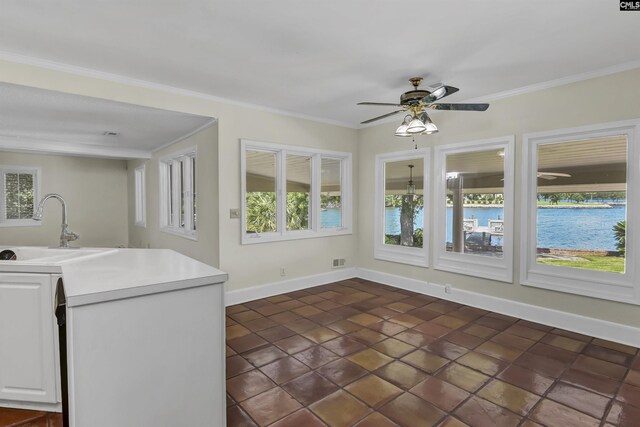 kitchen featuring black dishwasher, a center island, a healthy amount of sunlight, and white cabinets