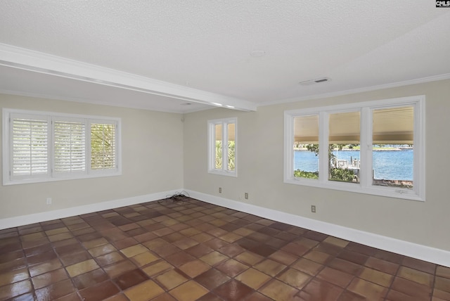 unfurnished room with visible vents, plenty of natural light, and baseboards