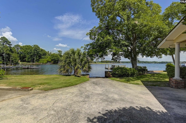 view of front of home featuring a water view and a front lawn