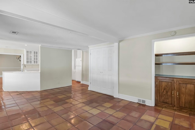 unfurnished living room with ornamental molding and dark tile patterned flooring