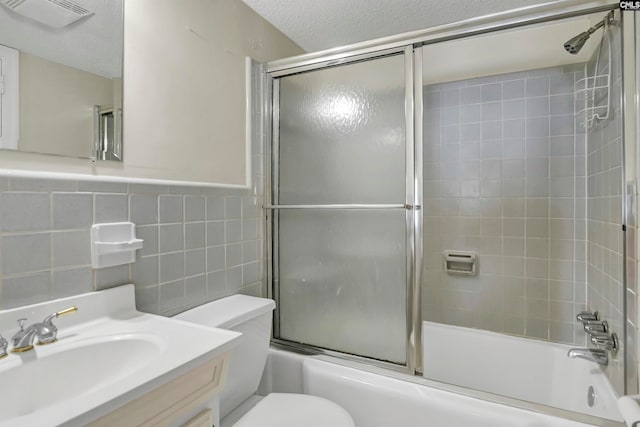 full bathroom with vanity, tasteful backsplash, tile walls, enclosed tub / shower combo, and toilet