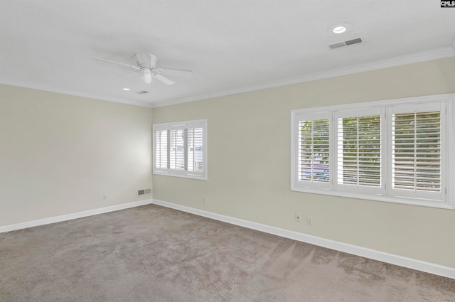 spare room featuring ornamental molding, carpet flooring, and ceiling fan