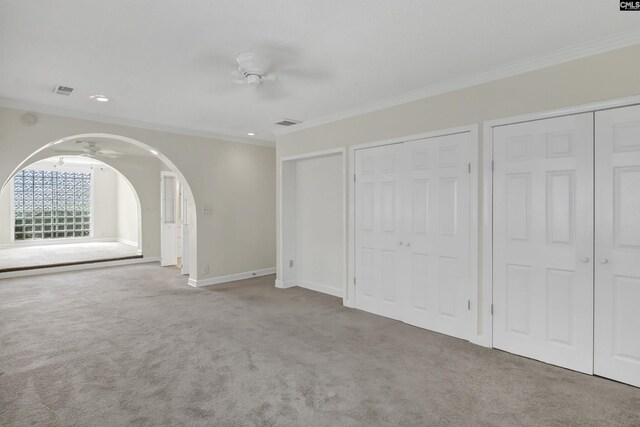 interior space with crown molding and light colored carpet