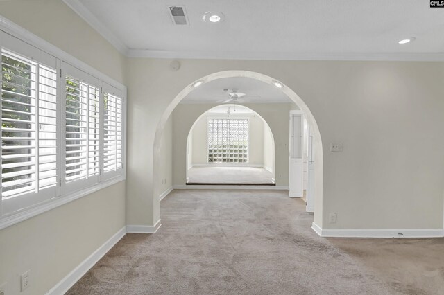 interior space featuring crown molding and light carpet