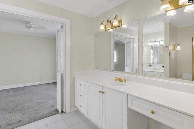 bathroom with tile patterned flooring, crown molding, vanity, and toilet