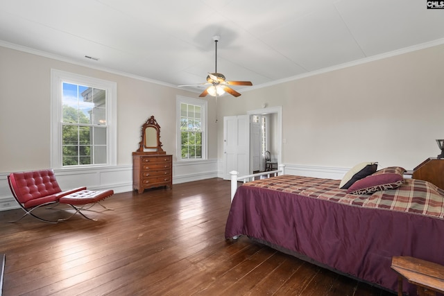 bedroom featuring crown molding, dark wood-type flooring, and ceiling fan