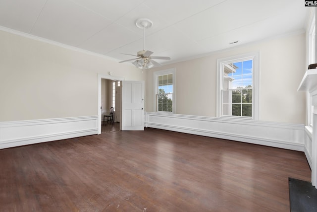 spare room with dark wood-type flooring, ceiling fan, plenty of natural light, and crown molding